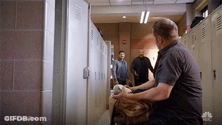 Man Sitting In Locker Room Holding Fur Coat GIF