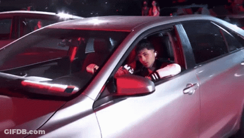 Man Sitting In Silver Car With M On Side GIF