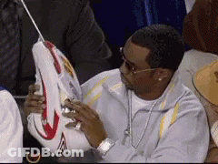 Man Sitting In Stadium Holding Basketball GIF