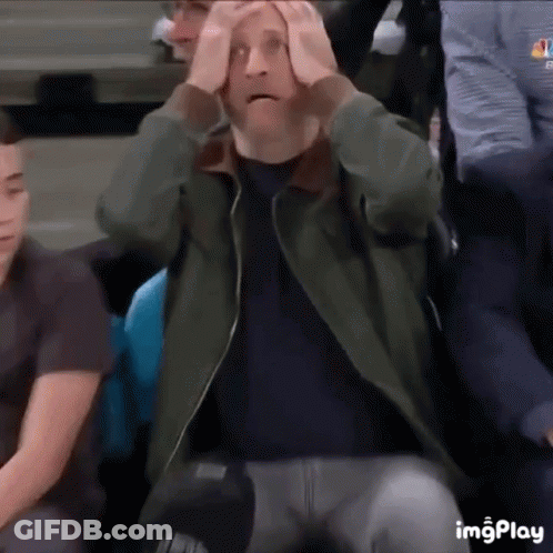 Man Sitting In Stadium With Hands On Head Surprised GIF