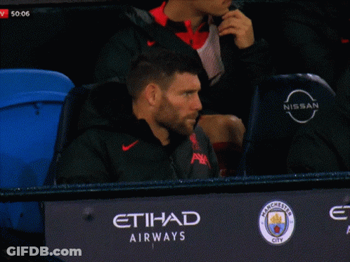 Man Sitting In Stadium With Nissan Logo GIF