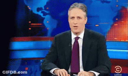 Man Sitting In Suit And Tie At Comedy Central Screen GIF