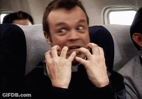 Man Sitting On Airplane Making Funny Face GIF