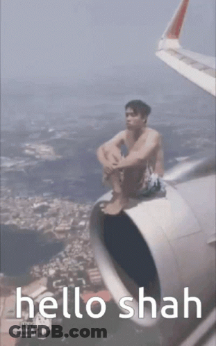 Man Sitting On Airplane Wing Saying Hello Shah GIF
