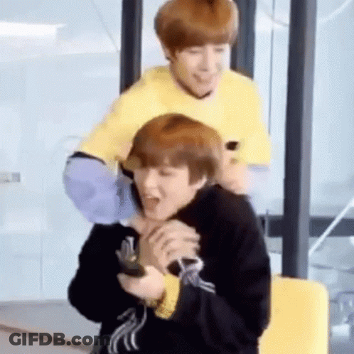 Man Sitting On Another Man's Shoulders Holding Remote Control GIF