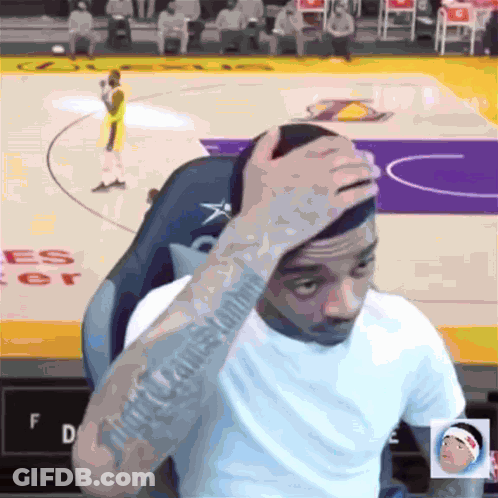 Man Sitting On Basketball Court With Hand On Head GIF