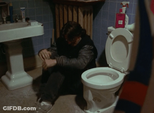 Man Sitting On Bathroom Floor Next To Toilet And Soap Spray Bottle GIF