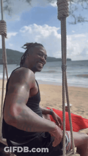 Man Sitting On Beach Swing Smiling GIF