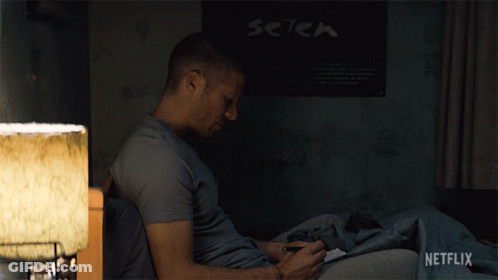 Man Sitting On Bed In Front Of Setek Poster GIF