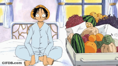 Man Sitting On Bed Next To Box Of Fruit GIF