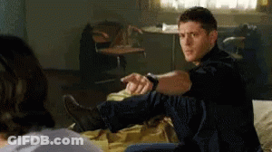 Man Sitting On Bed Stretching Leg GIF