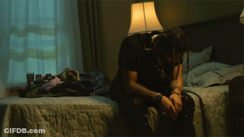 Man Sitting On Bed With Head Down GIF