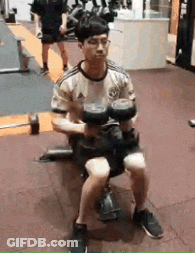 Man Sitting On Bench Holding Dumbbell GIF