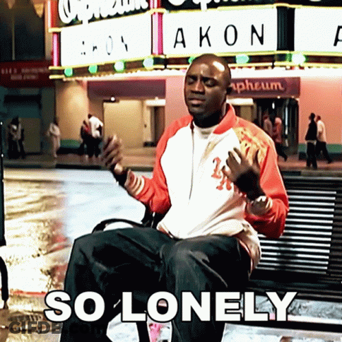 Man Sitting On Bench In Front Of Akon Sign GIF