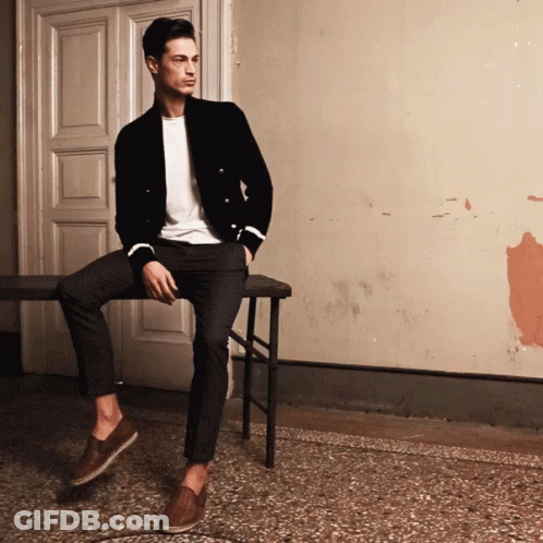Man Sitting On Bench In Front Of Door GIF