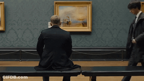 Man Sitting On Bench In Front Of Painting GIF