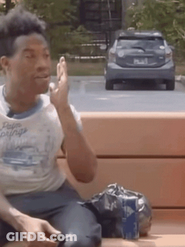 Man Sitting On Bench With Car In Background GIF