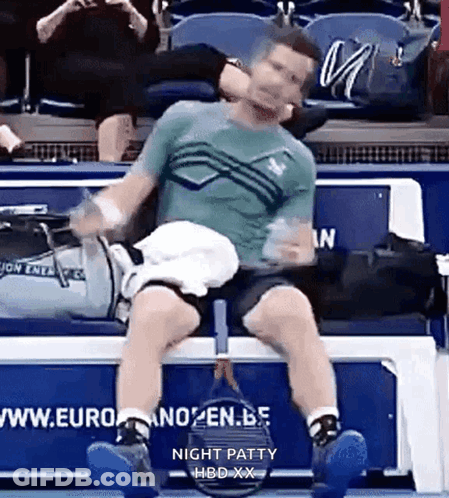 Man Sitting On Bench With Tennis Racquet GIF