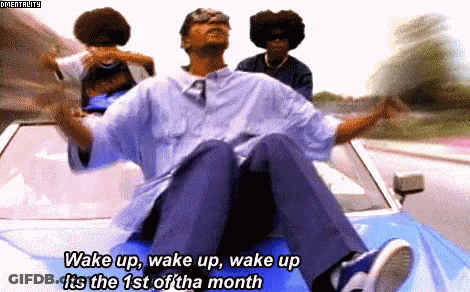 Man Sitting On Car With Wake Up Text GIF