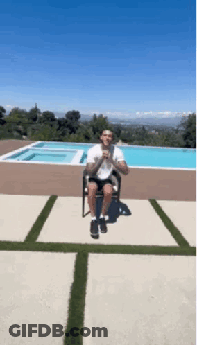 Man Sitting On Chair In Front Of Pool GIF