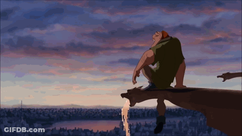Man Sitting On Cliff Edge With Sunset GIF