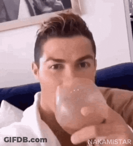 Man Sitting On Couch Drinking Water GIF