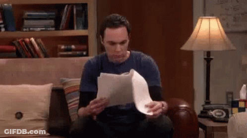 Man Sitting On Couch Holding Paper GIF