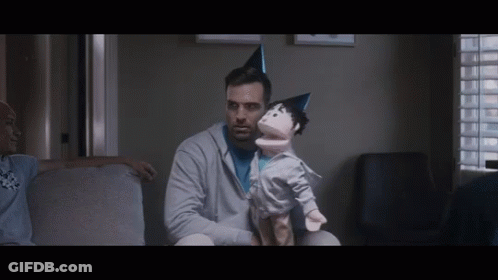 Man Sitting On Couch Holding Puppet GIF