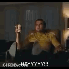Man Sitting On Couch Holding Remote And Beer GIF