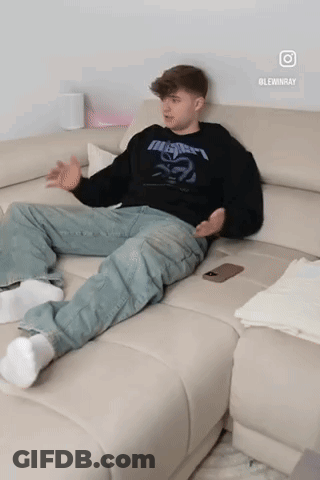 Man Sitting On Couch In Black Metallica Shirt GIF