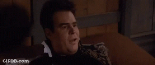 Man Sitting On Couch In Dark Room Talking GIF