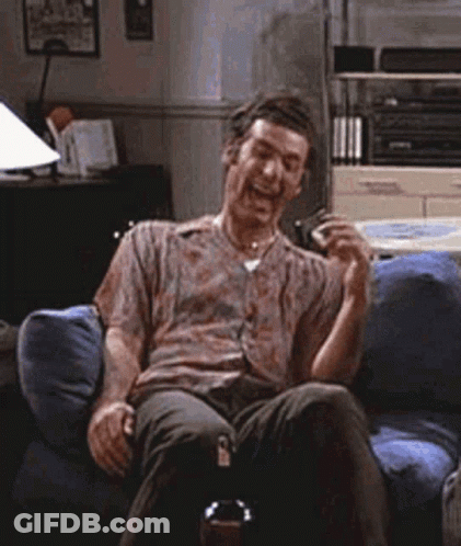 Man Sitting On Couch Laughing With Beer GIF
