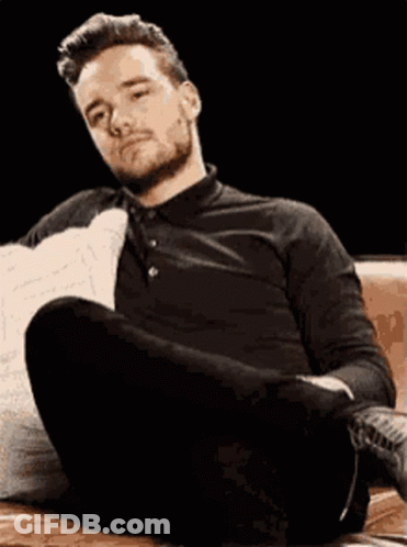 Man Sitting On Couch Legs Crossed Head Down GIF