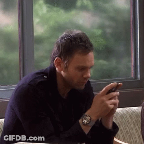 Man Sitting On Couch Looking At Phone GIF