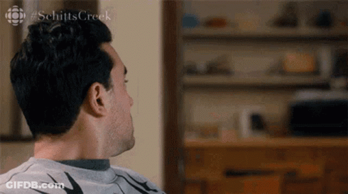 Man Sitting On Couch Looking Away GIF