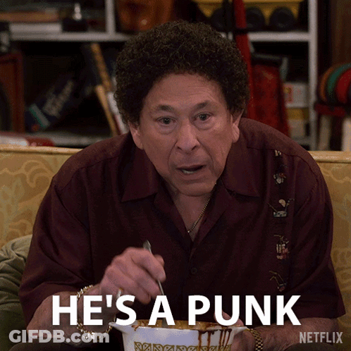 Man Sitting On Couch Netflix Ad Saying Punk GIF