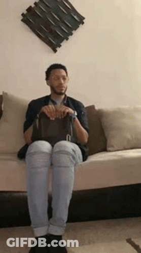 Man Sitting On Couch Petting Black Cat GIF