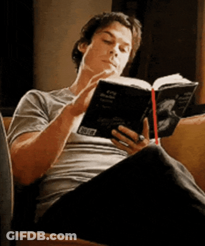 Man Sitting On Couch Reading Book With Ring GIF