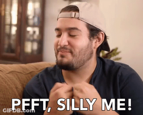 Man Sitting On Couch Saying Pfft Silly Me GIF