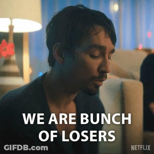 Man Sitting On Couch Saying We Are Losers GIF