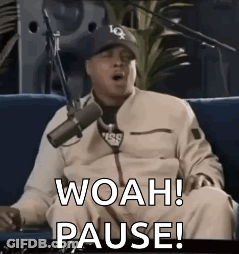 Man Sitting On Couch Saying Woah Pause GIF