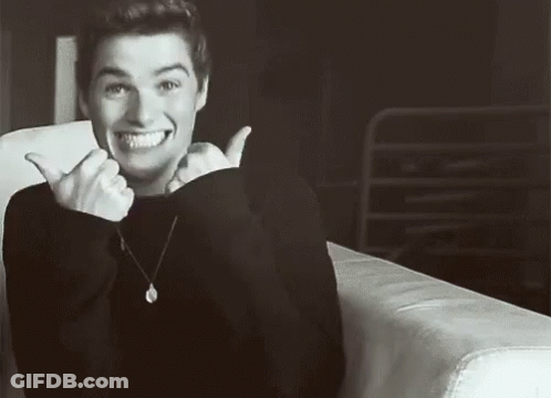 Man Sitting On Couch Smiling GIF