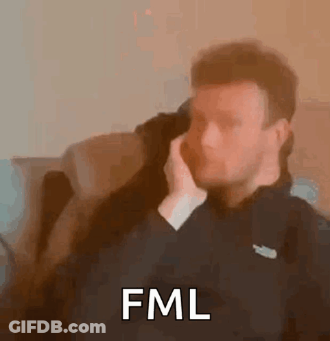 Man Sitting On Couch Talking On Phone Saying FML GIF