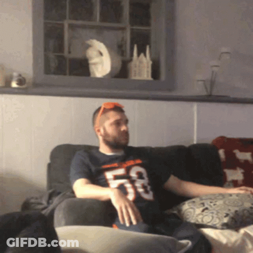 Man Sitting On Couch Wearing 53 Shirt GIF
