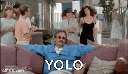 Man Sitting On Couch With Arms Outstretched Surrounded By People GIF