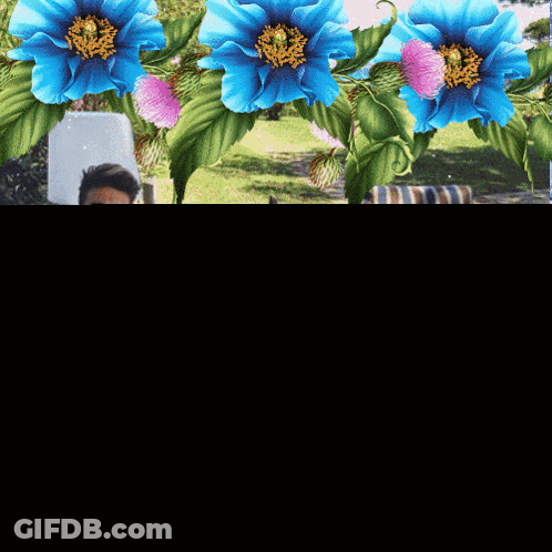 Man Sitting On Couch With Blue Flowers GIF