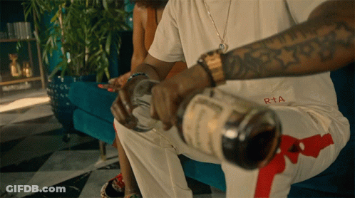 Man Sitting On Couch With Bottle Of RTA GIF