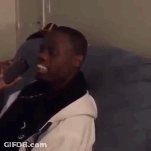 Man Sitting On Couch With Cell Phone GIF
