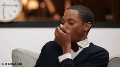 Man Sitting On Couch With Clock Background GIF