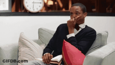 Man Sitting On Couch With Clock GIF